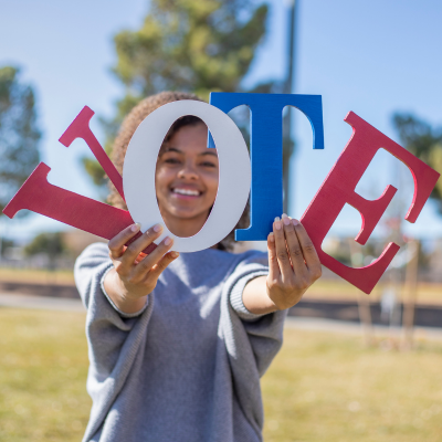 A closeup photo of a mural that reads VOTE